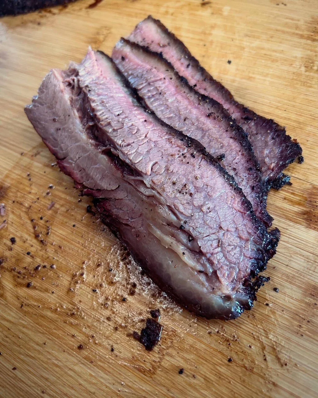 Sliced AM Barbecue brisket on a cutting board